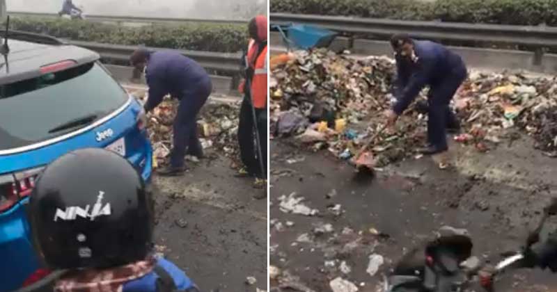 Delhi Cop Steers Away Garbage At The DND Flyway
