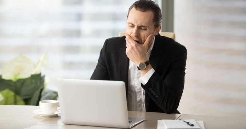 Man Yawning at Work | Why We Feel Like Waking Up Even Without taking a Nap