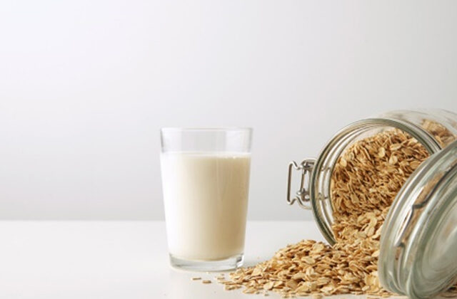Glass of Oat Milk Alongside a Jar of Oats | Benefits of Oat Milk