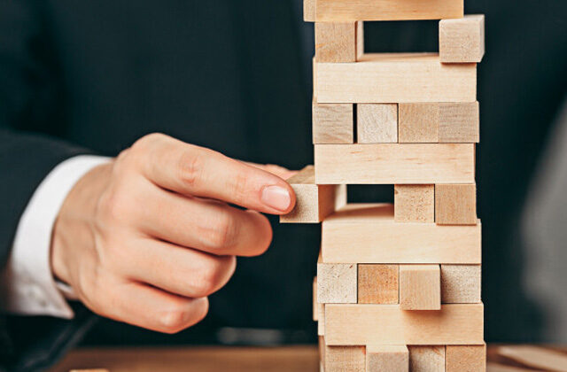 Businessman playing jenga | important life skills