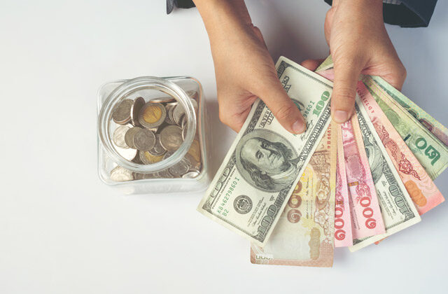 person counting dollars | How To Save Money