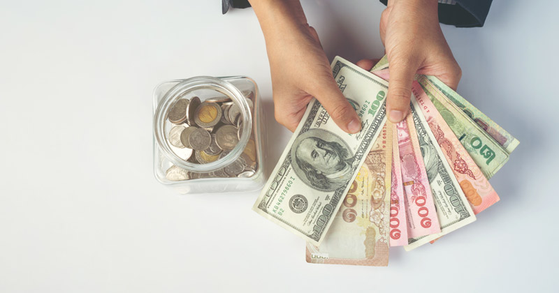 person counting dollars | How To Save Money