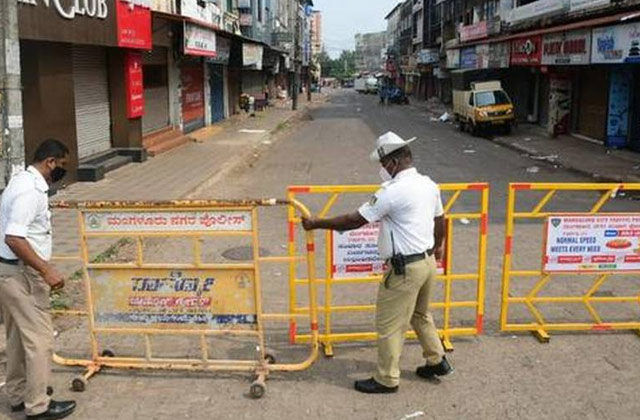 Traffic police personnels placing barriers on road | Karnataka Lockdown