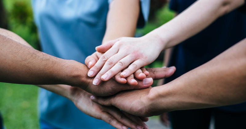 People of different ethnicity putting their hand on hand | Culture