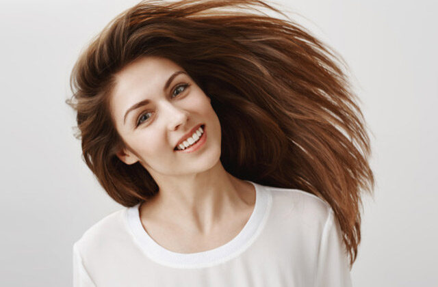 Smiling woman with long hair | Good Castor Oils for Hair