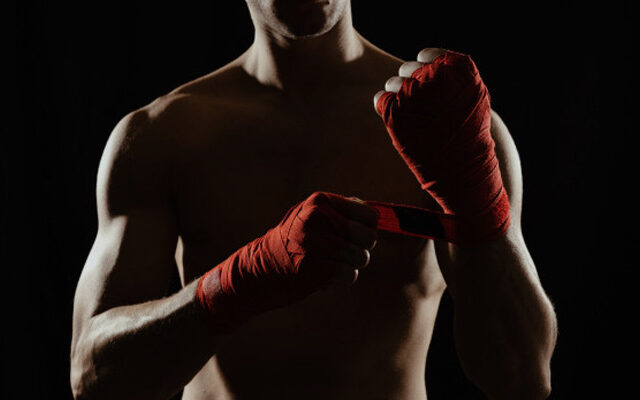 A Boxer Tightening his hand straps |
