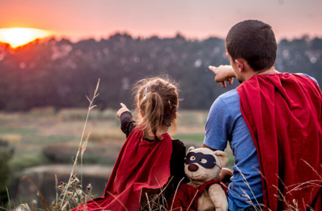 Father and Daughter Wearing Super hero costume and staring at sun | Zodiac Signs As Dads
