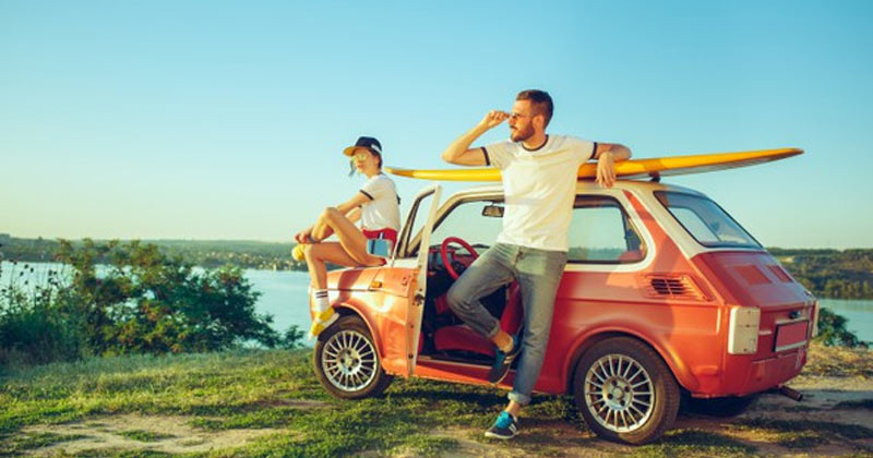 Two Friends Resting Near Lakeside | Zodiac Signs Travel Buddies