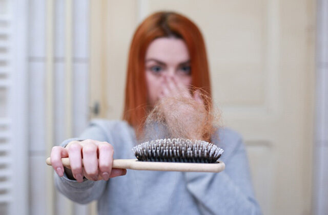 A Woman Showing her broken hair strands on a comb | Hair Loss Prevention Tips