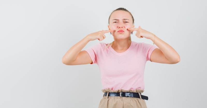 Woman Pointing at her upper lip | How to Remove Upper Lip Hair At Home